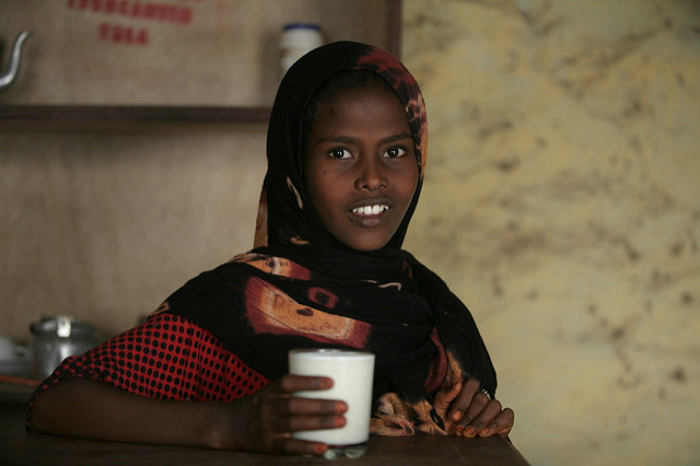 Girl with a glass of milk in Afar, Ethiopia