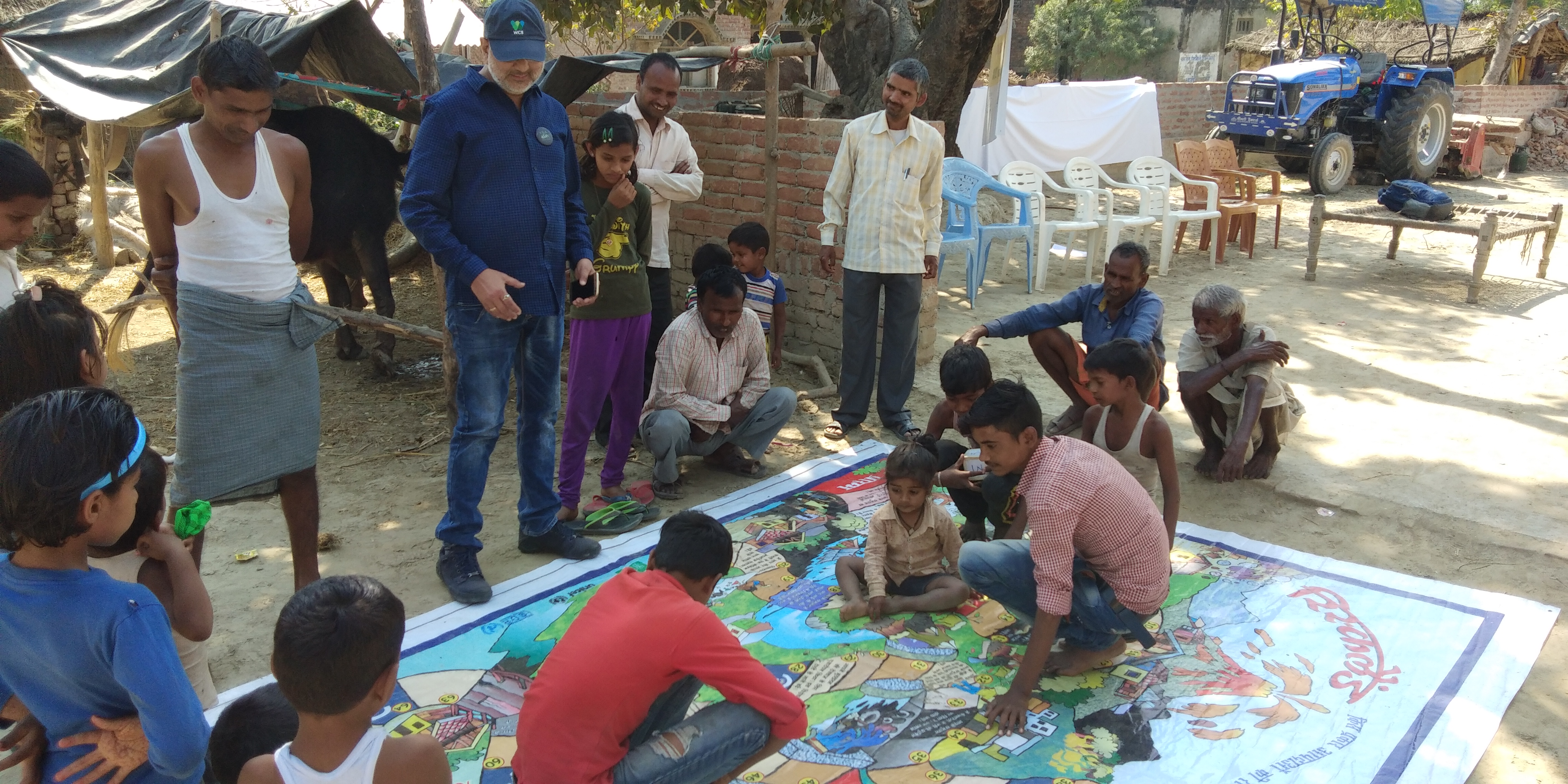 CEE Himalaya teaches community members about disaster risk reduction by playing the Riskland game.
