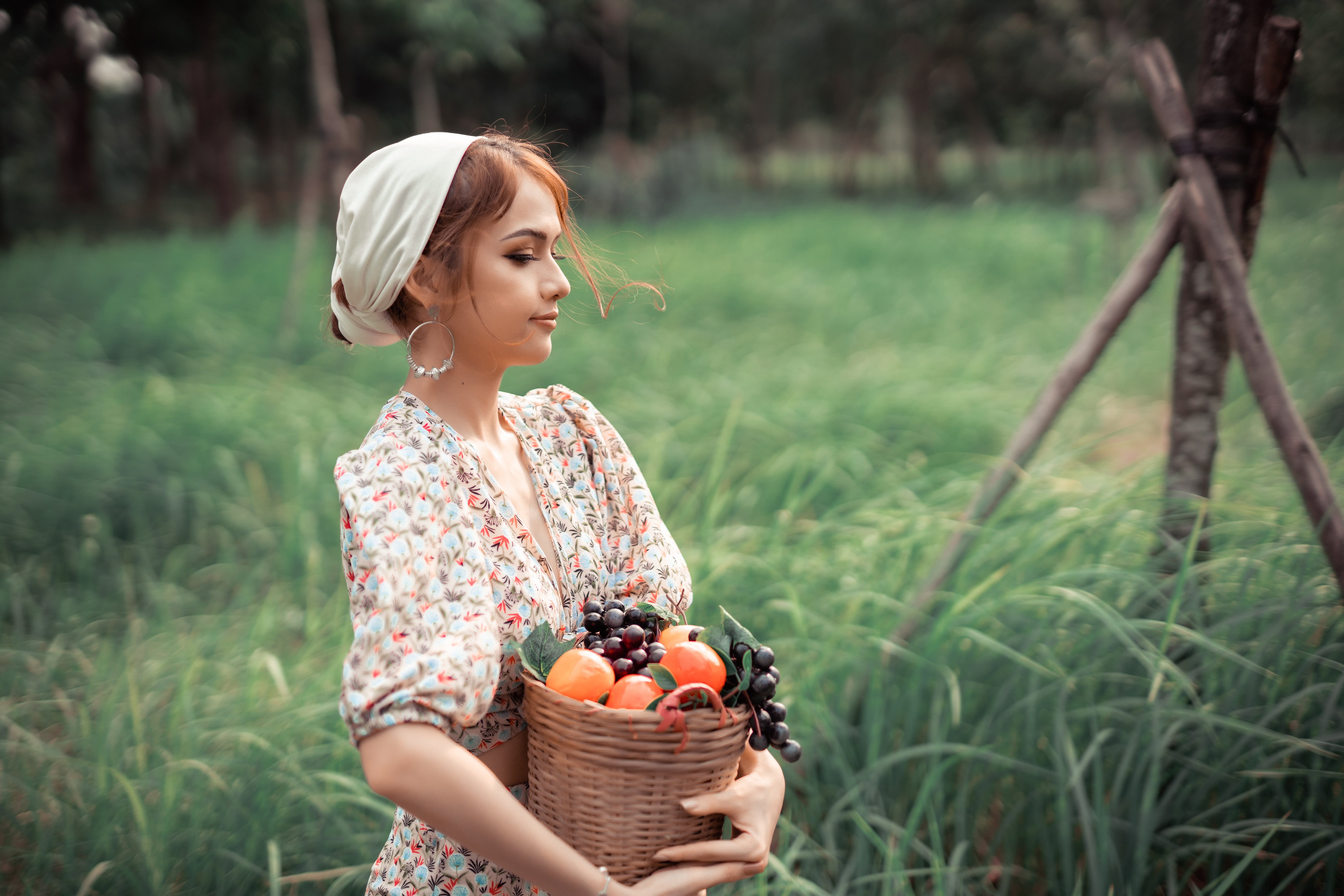 young woman holding basket with fruits