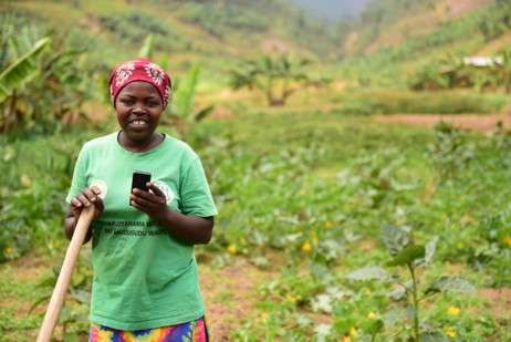 Photo with farmer using DSP in Rwanda