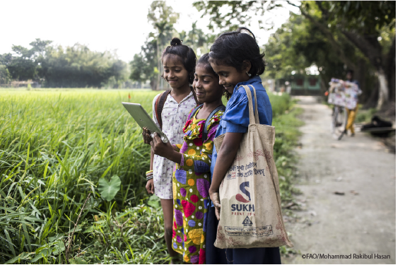 Panjarbhanga, Bangladesh - Children use a computer tablet as a learning device ©FAOMohammad Rakibul Hasan